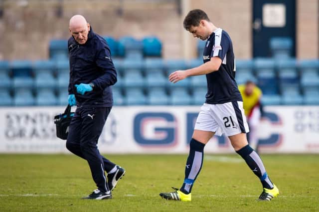 Dundee's Darren O'Dea goes off with an injury against Inverness CT. Picture: SNS