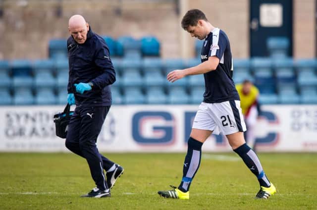 Dundee's Darren O'Dea goes off with an injury against Inverness CT. Picture: SNS