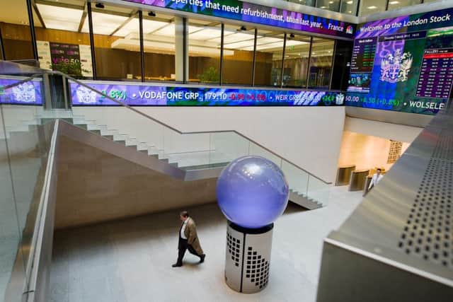 People walk in the foyer of the London Stock Exchange. Picture: Getty Images