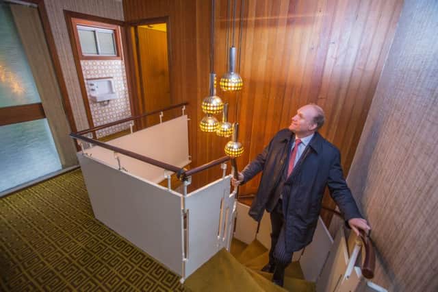Jonathan Riley from the agent Rettie in the in the hall with the period stairs and lamps. Picture: Hemedia