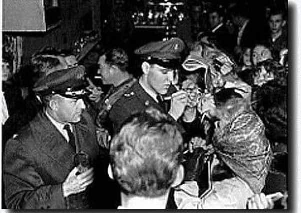 Elvis signs autographs after landing at Prestwick airport in 1960.