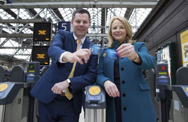 Scotrail Alliance Commercial Director Cathy Craig, right, and Transport Minister Derek Mackay show off their smartcards. Picture: SNS