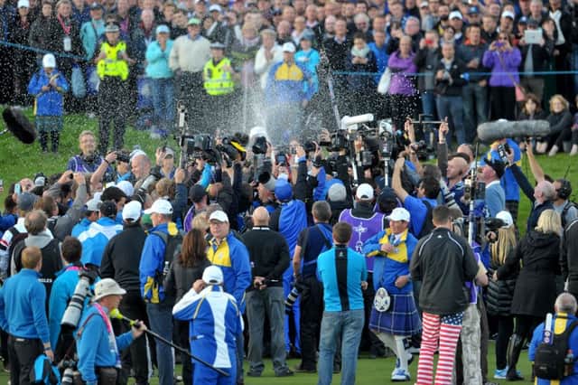 Members of the press gather round the European players on the 18th green after they win the 2014 Ryder Cup at Gleneagles. Picture: Jane Barlow