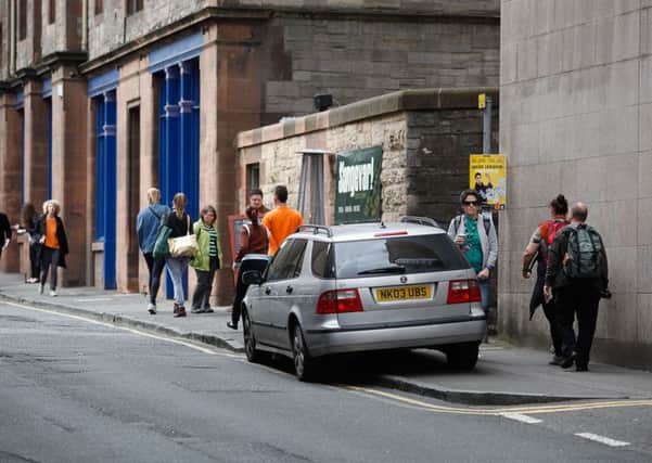 A car parked on a pavement in Edinburgh's Cowgate. Picture: Scott Louden