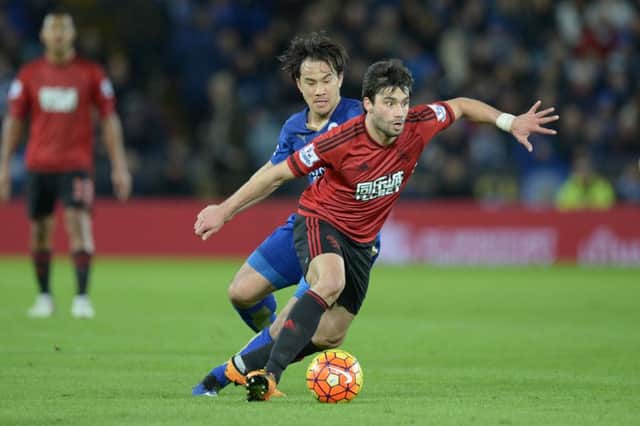 West Bromwich Albion midfielder Claudio Yacob, right, vies with Leicester Citys Japanese striker Shinji Okazaki. Picture: Getty Images