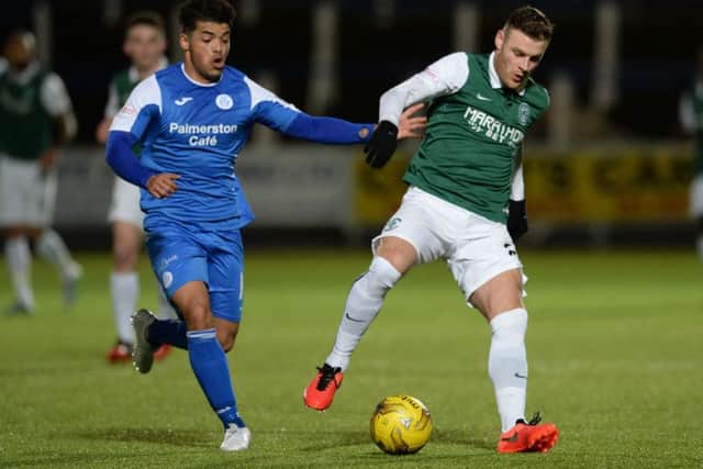Queen of the South's Callum Tapping battles with Hibernian's Anthony Stokes. Picture: SNS