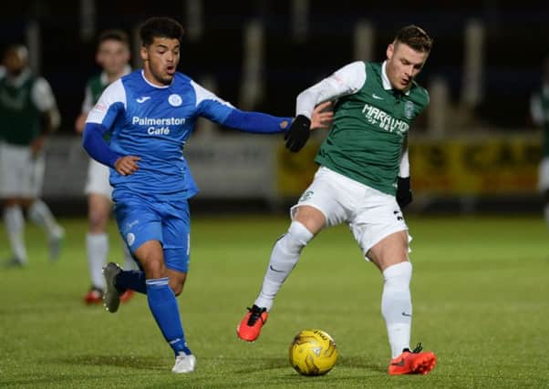 Queen of the South's Callum Tapping battles with Hibernian's Anthony Stokes. Picture: SNS