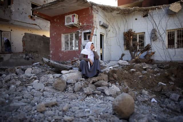 A woman surveys the damage in the mainly Kurdish town of Cizre. Picture: AP