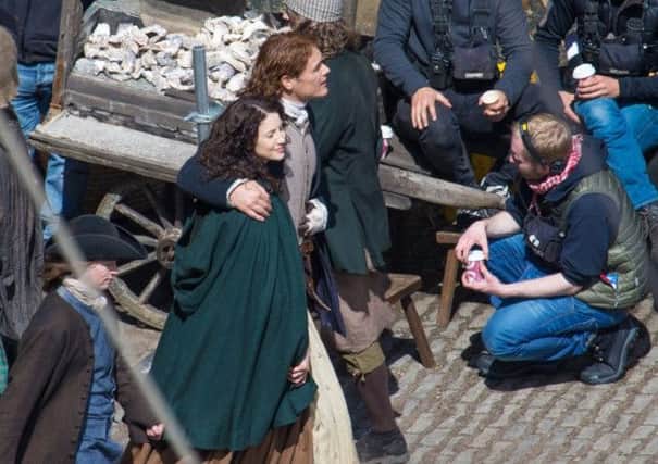 Scots actor Sam Heughan and co-star Caitriona Balfe on the set of Outlander in Dysart in Fife