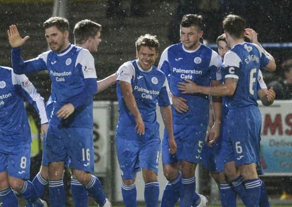 Andy Murdoch, centre, celebrates scoring the winner for Queen of the South against Hibs on Tuesday night. Picture: SNS