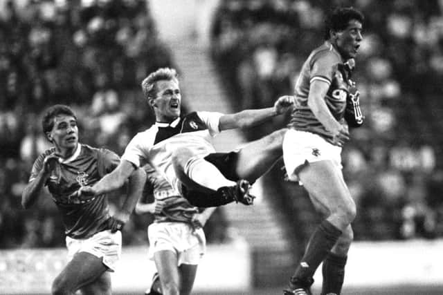 Rangers'
Ted McMinn feel the full force of a John Brown challenge as Ally McCoist looks on during a Skol Cup tie with Dundee in 1986. Picture: SNS