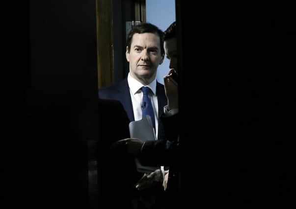 Chancellor George Osborne is seen through an open door as he waits to speak at the British Chambers of Commerce annual conference in London on Thursday. Picture: Kirsty Wigglesworth/AP