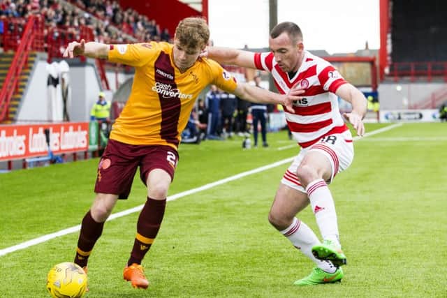 Motherwell's Chris Cadden holds off Darian MacKinnon (right)