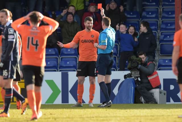 Dundee Utd's Mark Durnan (centre) is shown the red card by referee Craig Thomson