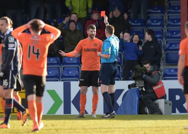 Dundee Utd's Mark Durnan (centre) is shown the red card by referee Craig Thomson