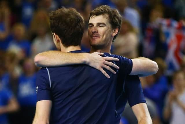 Hugs all round as Andy and Jamie Murray celebrate a straightforward doubles victory in Birminghams Barclaycard Arena. Photograph: Jordan Mansfield/Getty