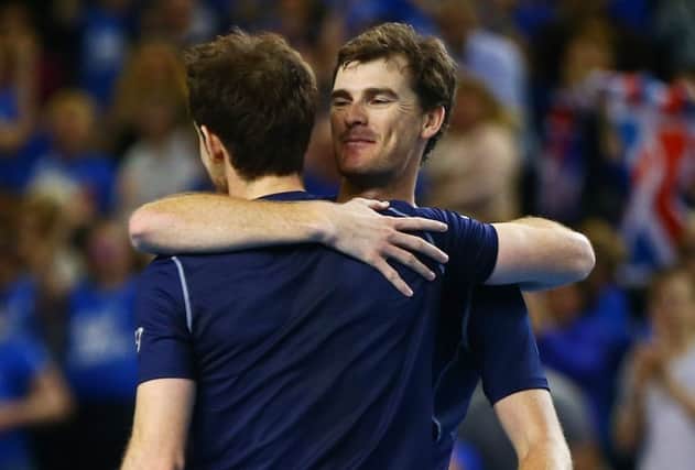 Hugs all round as Andy and Jamie Murray celebrate a straightforward doubles victory in Birminghams Barclaycard Arena. Photograph: Jordan Mansfield/Getty