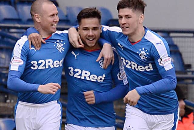 Harry Forrester, centre, celebrates after scoring the opening goal for Rangers with Kenny Miller, left, and Rob Kiernan, right. Picture: SNS Group