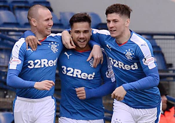 Harry Forrester, centre, celebrates after scoring the opening goal for Rangers with Kenny Miller, left, and Rob Kiernan, right. Picture: SNS Group