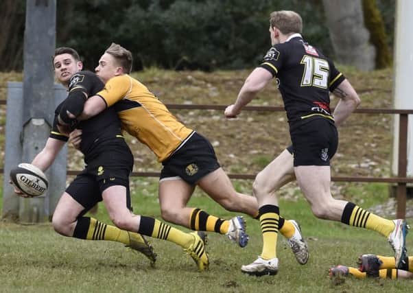Curries Harvey Elms tackles Joe Helps as he offloads to Fraser Thompson who went on to score. Picture: Ian Rutherford
