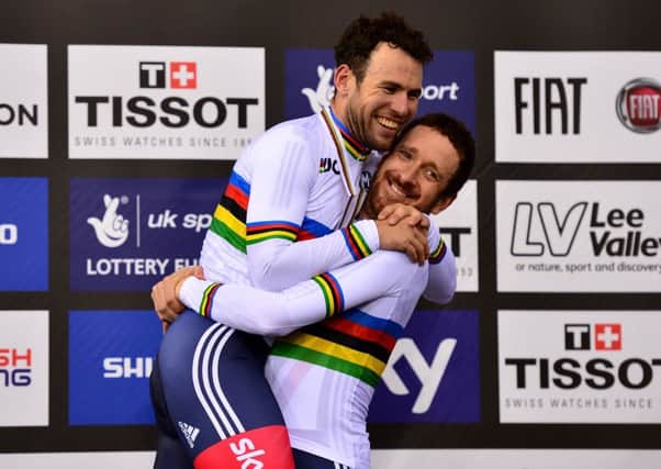 Sir Bradley Wiggins, right, lifts Mark Cavendish on the medal podium while, inset, Laura Trott celebrates her omnium victory. Picture: Getty Images