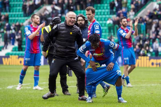 Inverness CT manager John Hughes (left) pulls down the shorts of Andrea Mbuyi-Mutombo at full-time. Picture: SNS