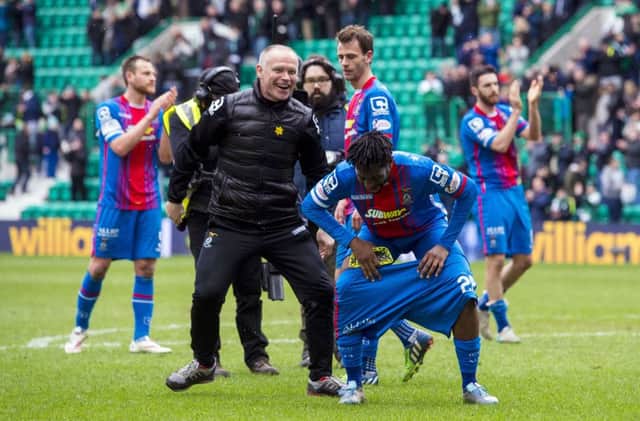 Inverness CT manager John Hughes (left) pulls down the shorts of Andrea Mbuyi-Mutombo at full-time. Picture: SNS