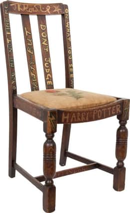 Before she first put the chair up for charity auction in 2002, Rowling refurbished it with Potter-themed inscriptions.