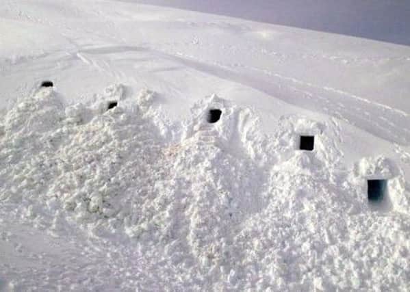 Military personnel have provided a sneak peek of the interiors of snow holes they dug while training in the Scottish Highlands.
The evenly-spaced six shelters were built with rectangular entrances. One even had steps up to it. Picture: SAIS