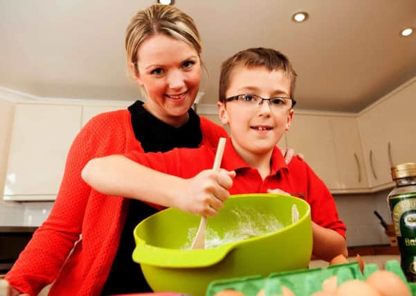 Josh Ferguson at work in the kitchen with mum Eilidh Mears. Picture: Toby Williams
