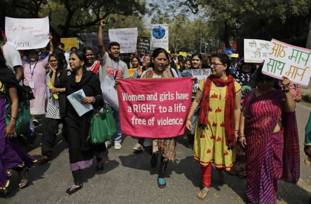 Women's rights activists hold banners and placards as they mach on International Women's Day in New Delhi. Picture: AP