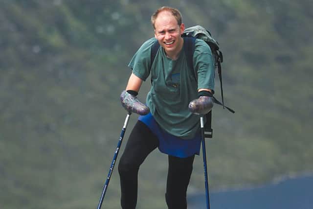 Jamie Andrew on the slopes of Ben Nevis, making use of the climbing polls he helped develop. The Scots mountaineer returned to climbing despite losing both of his hands and feet to frostbite. Picture: Contributed