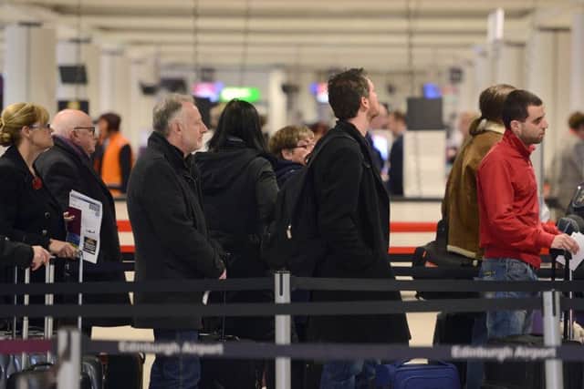 Passengers queue for the check-in desk at Edinburgh Airport. Picture: TSPL