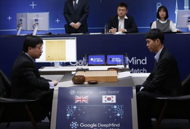 South Korean professional player Lee Sedol, right, faces AlphaGolead programmer Aja Huang. Picture: AP