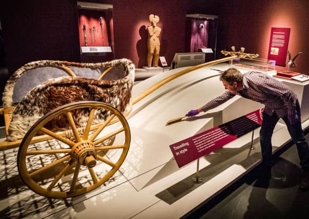 Assistant curator Craig Angus with the reconstruction of a chariot from a burial excavated at Newbridge in 2001. Picture: Scott Taylor