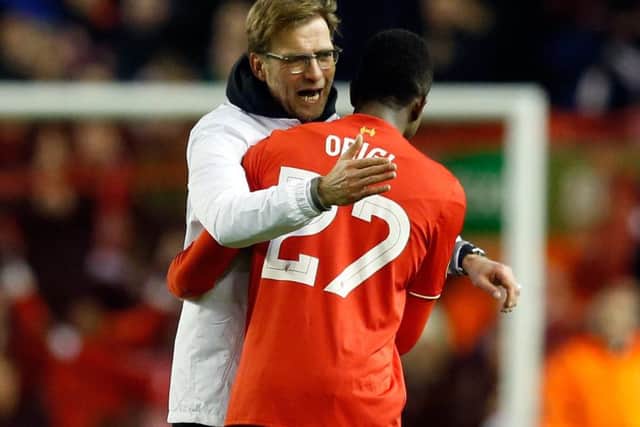 Liverpool manager Jurgen Klopp, left, celebrates with Divock Origi. Picture: Jon Super/AP