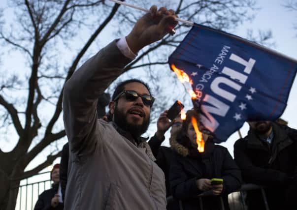 A protester burns a flag outside of the University of Illinois at Chicago Pavilion. Picture: Getty