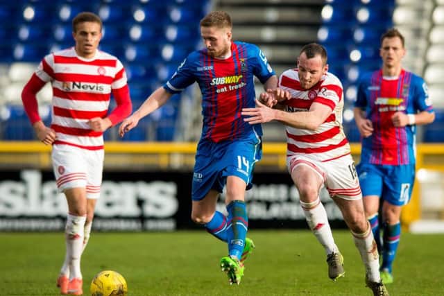 Danny Devine battles with Hamilton's Darian MacKinnon. Picture: SNS Group