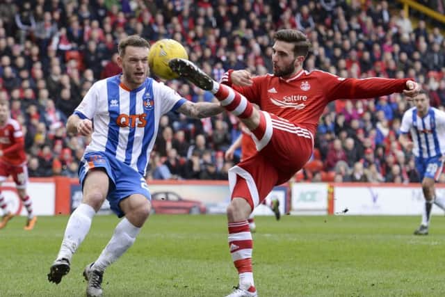 Aberdeens Graeme Shinnie reaches the ball ahead of Kilmarnocks Lee Hodson. Picture: SNS