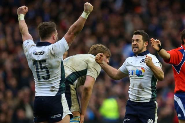 Stuart Hogg and skipper Greig Laidlaw celebrate Scotlands 29-18 victory over France as the final whistle blows at a packed Murrayfield Stadium. Picture: Getty