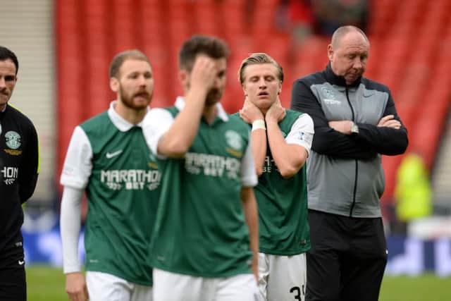 Jason Cummings and the rest of the Hibs players cut dejected figures on the Hampden pitch at the end after slipping to defeat against County. Picture: SNS