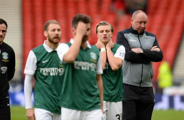 Jason Cummings and the rest of the Hibs players cut dejected figures on the Hampden pitch at the end after slipping to defeat against County. Picture: SNS