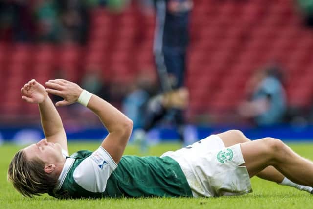 Jason Cummings lies prostrate on the Hamdpen turf hardly able to believe Hibs have lost the game