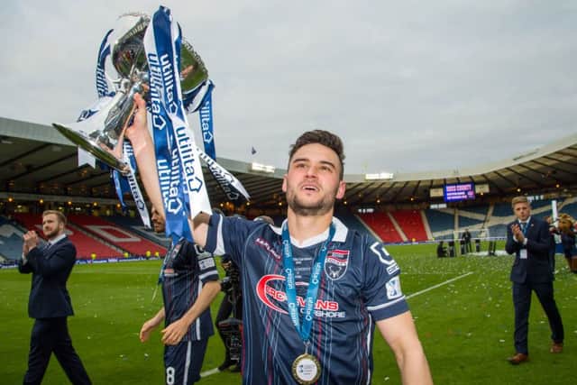 Ross County's Alex Schalk celebrates with the trophy. Picture: SNS