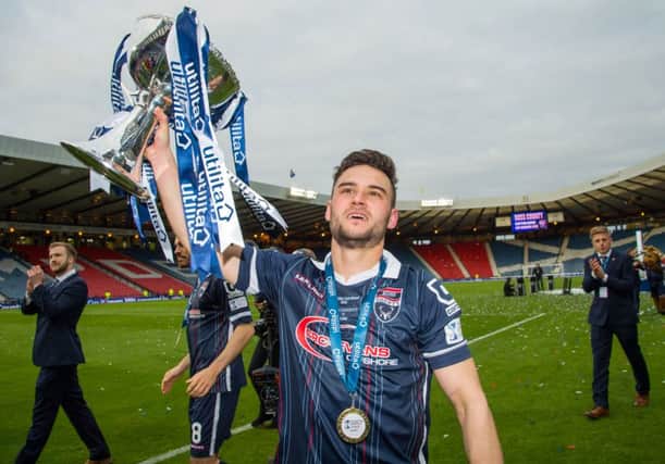 Ross County's Alex Schalk celebrates with the trophy. Picture: SNS