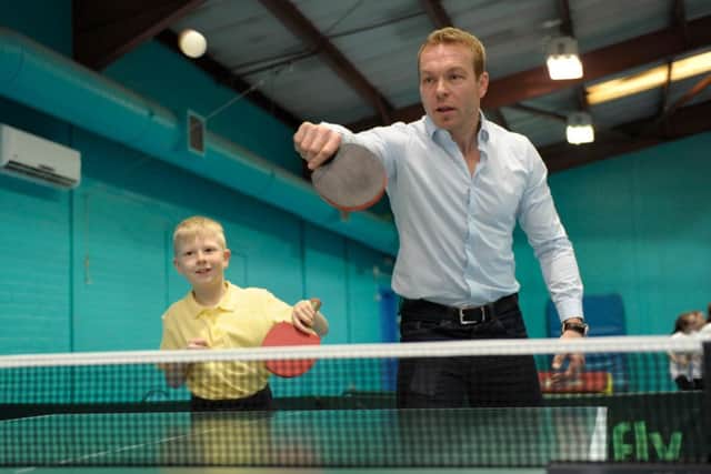Olympic champion Sir Chris Hoy tries his hand at rackets sports, with Liam Sanders, 9,  at Drumchapel Sports Centre