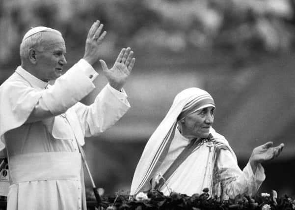 Mother Teresa and Pope John Paul II waving to well-wishers, at the Nirmal Hriday Home, in Calcutta, 1986 Picture: Jean-Claude Delmas/ Getty Images