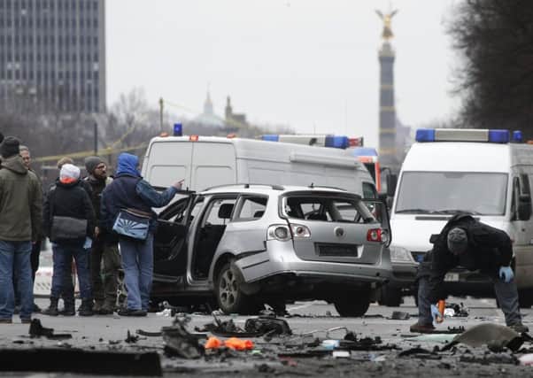 A police investigator stands on the site of the blast after a car exploded in Berlin. Picture: AP