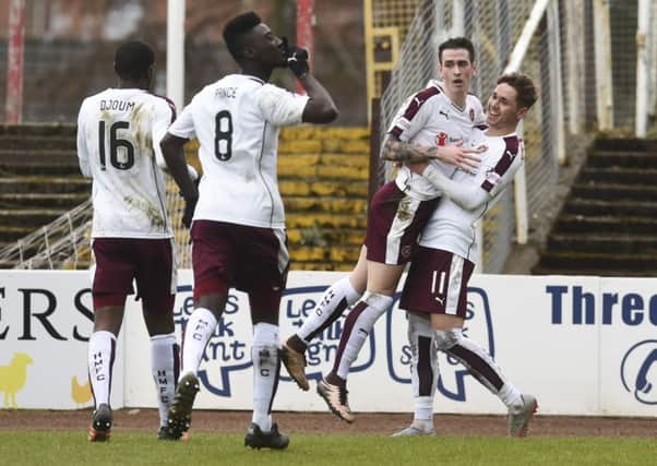 Jamie Walker (second from right) and Arnaud Djoum (left) played key roles in Hearts' victory over Dundee. Picture: SNS