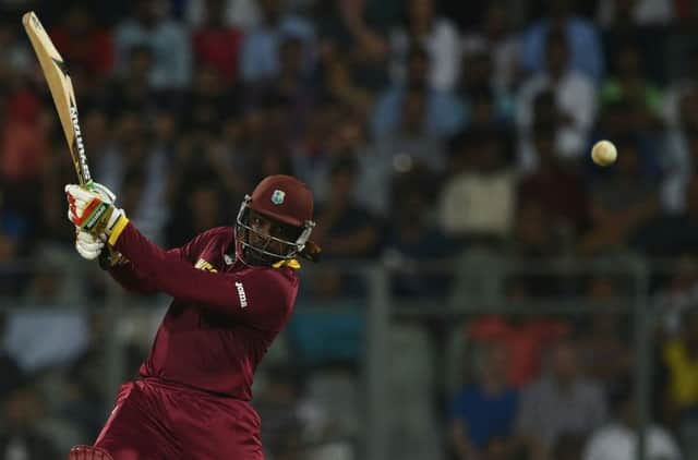 Chris Gayle smashes another six on his way to 100 not out and victory over England. Picture: Getty